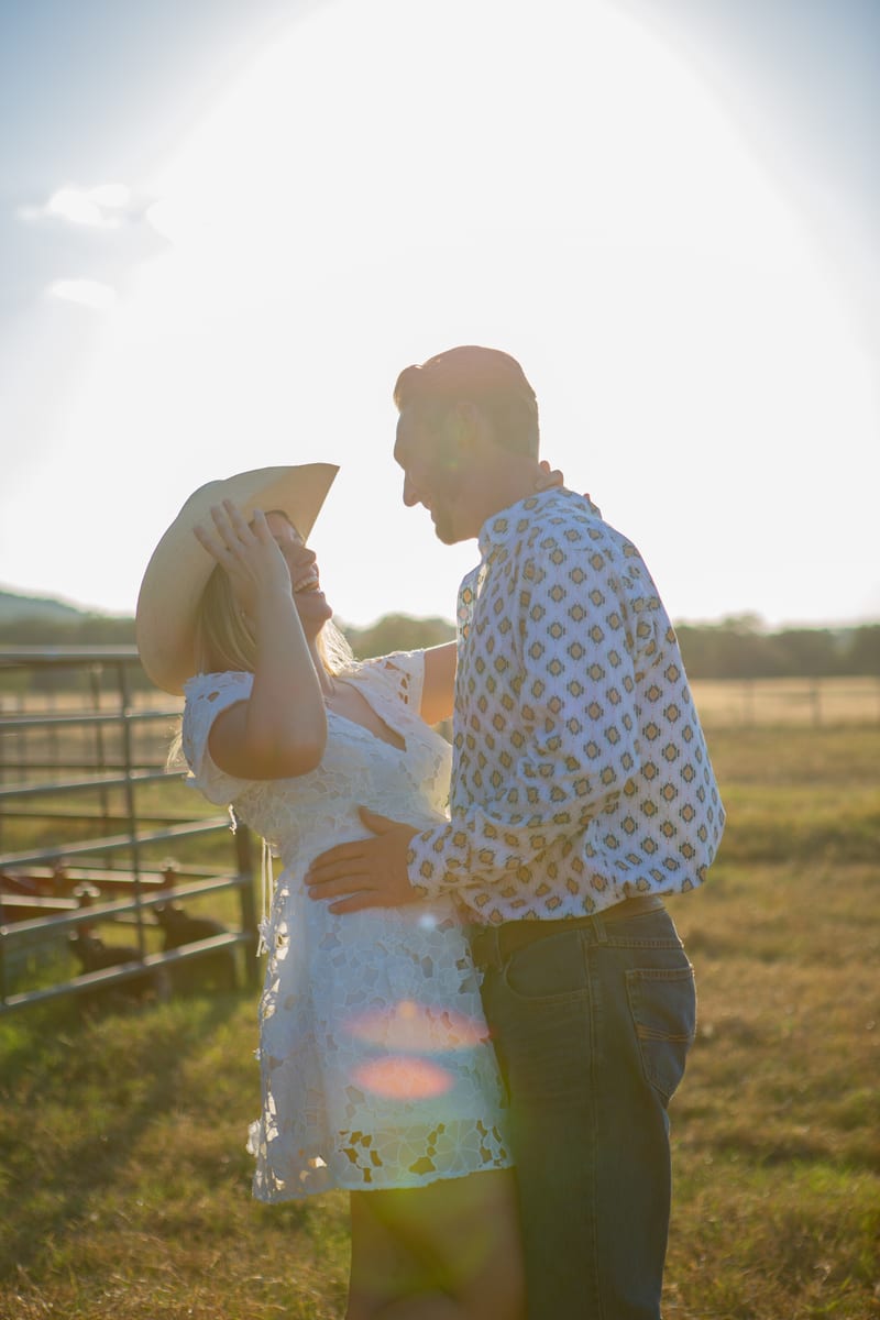 A couple with the sun flaring behind them